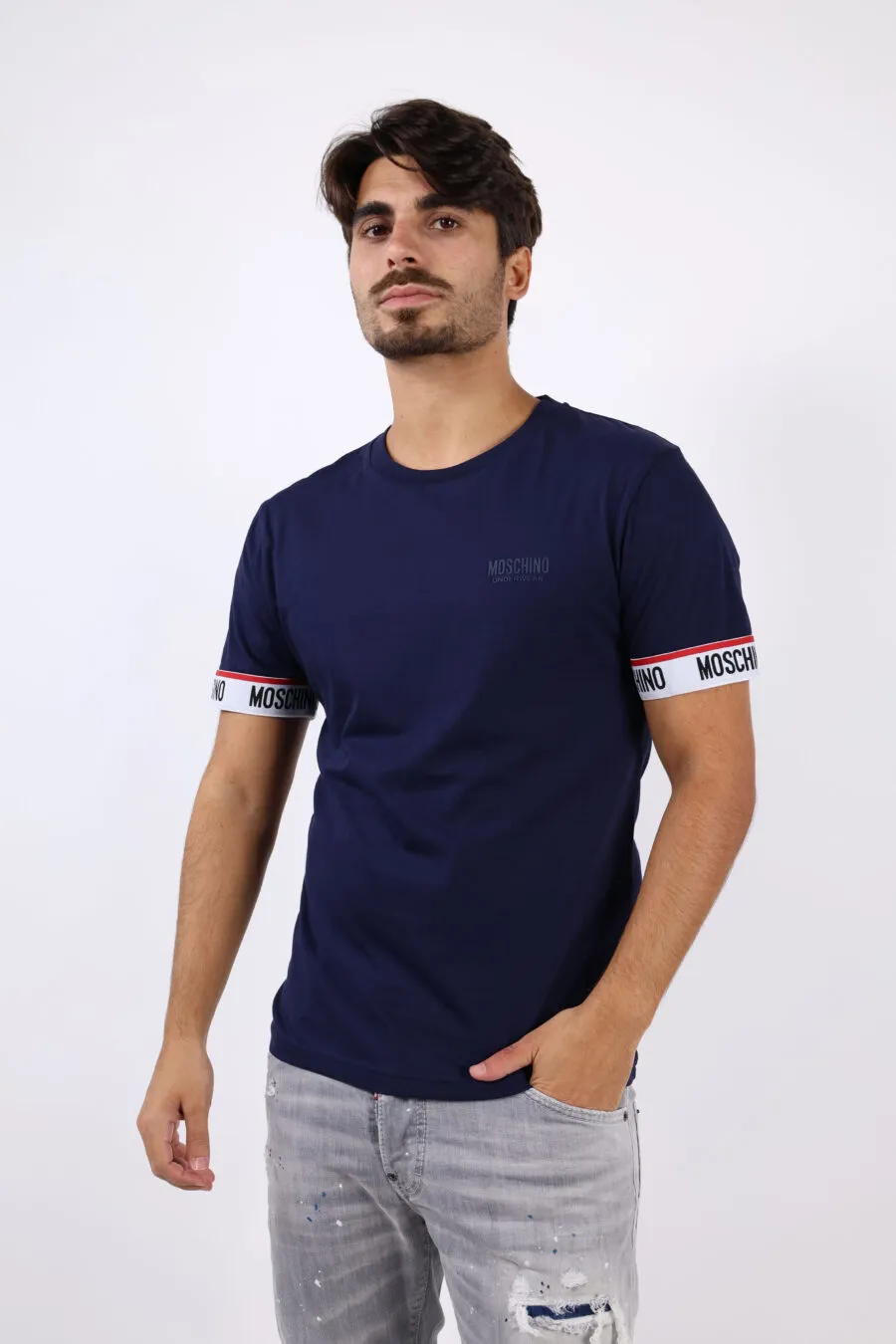 Camiseta azul con logo y línea roja en mangas